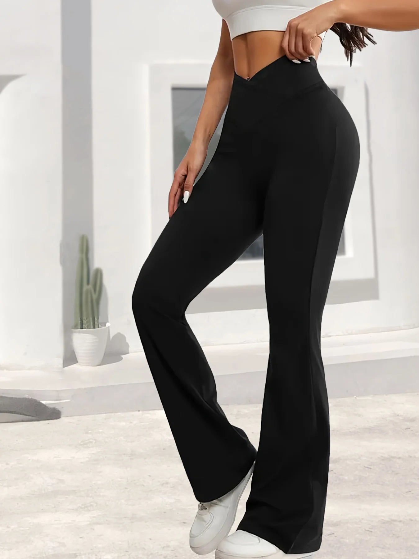A Spring Black Leggings With High Waist Elasticity, Slightly Flared Hems, Cross Waist Design, Suitable For Casual Sports